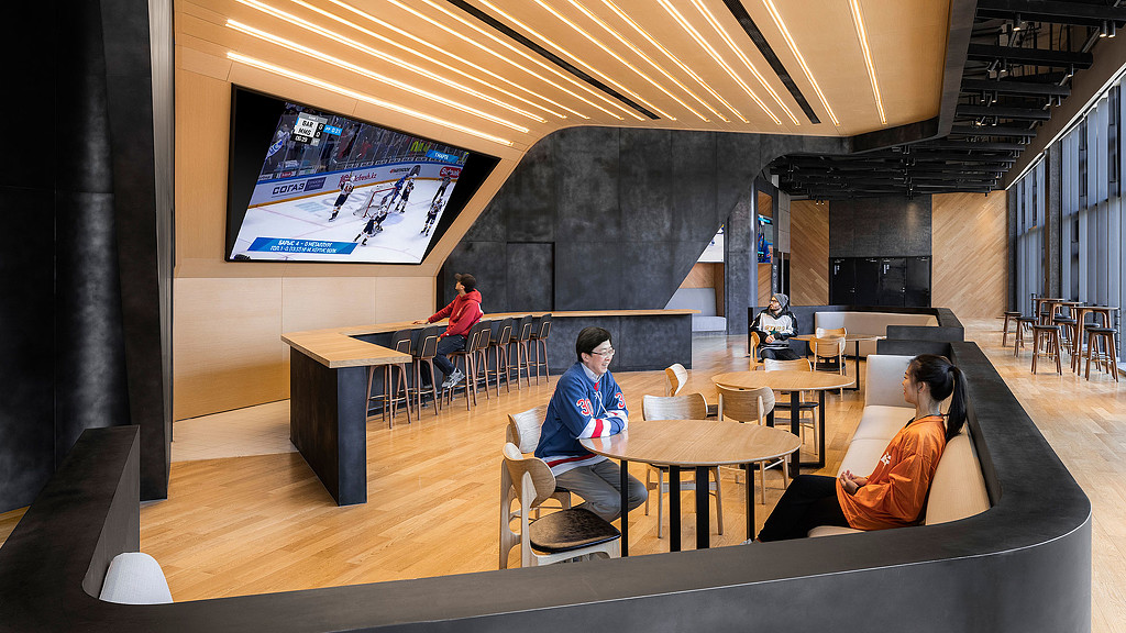 People sitting at tables in a room.