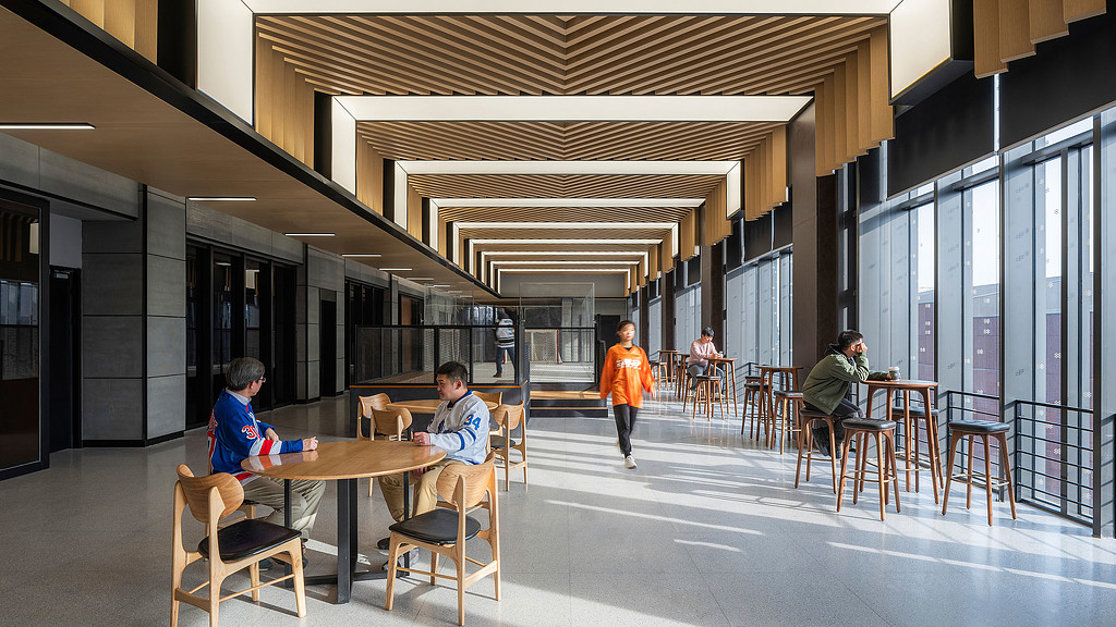 People sitting at tables in a building.