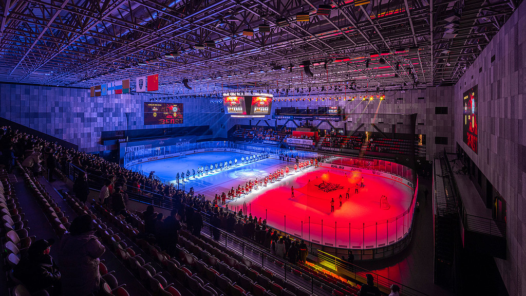 A sports arena with a crowd of people.
