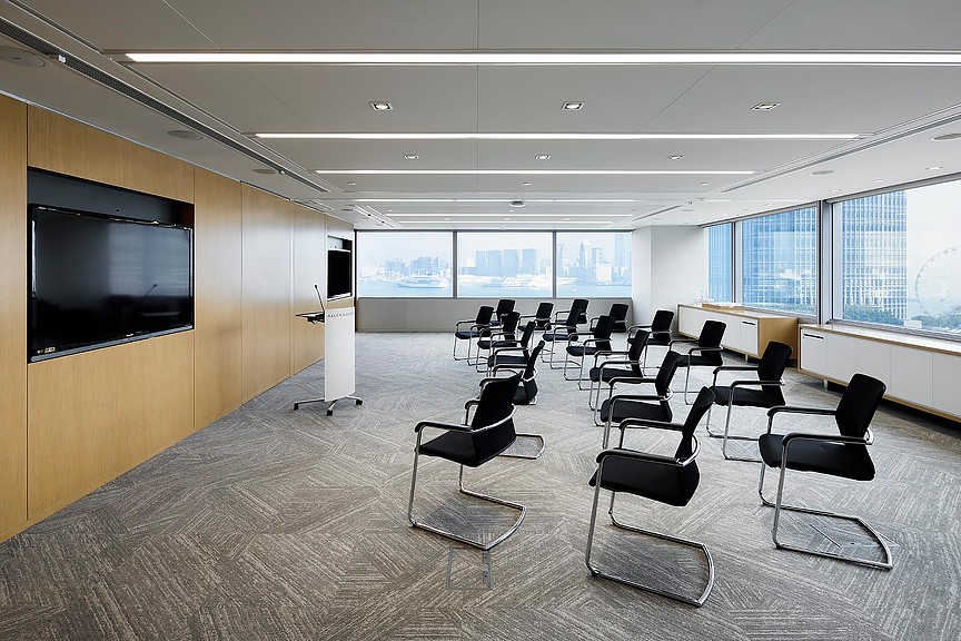 A room with chairs and a tv.