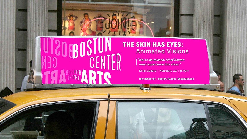 A large pink sign on a car.