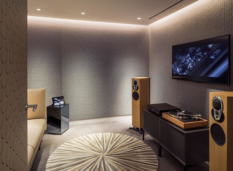 A bedroom with a large television.