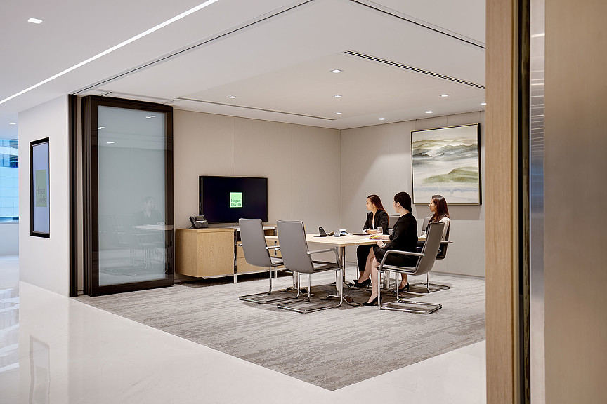 A group of people sitting at a table in a room.