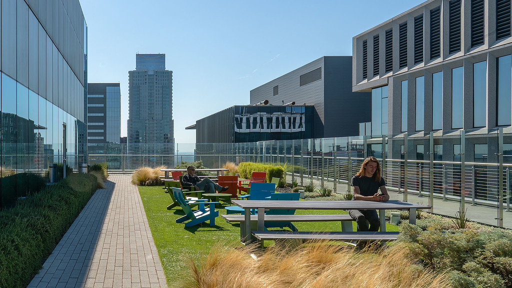 A few people sitting on a bench.