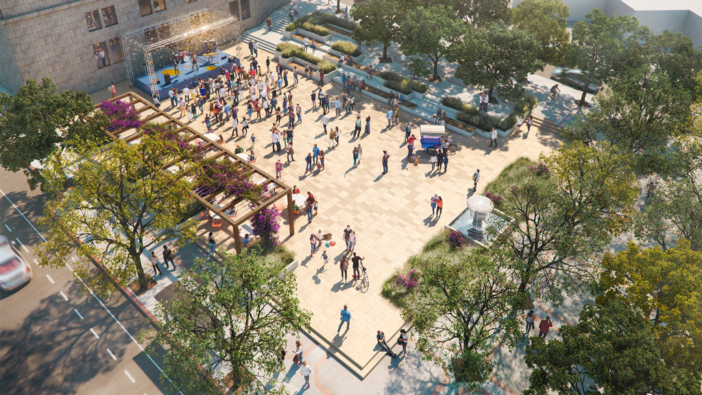 A group of people walking around a park.