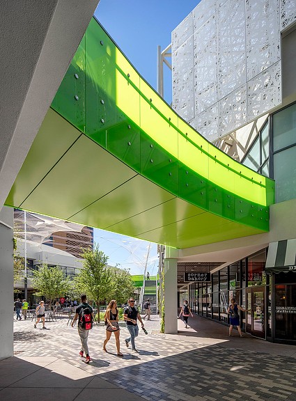 People walking under a bridge.