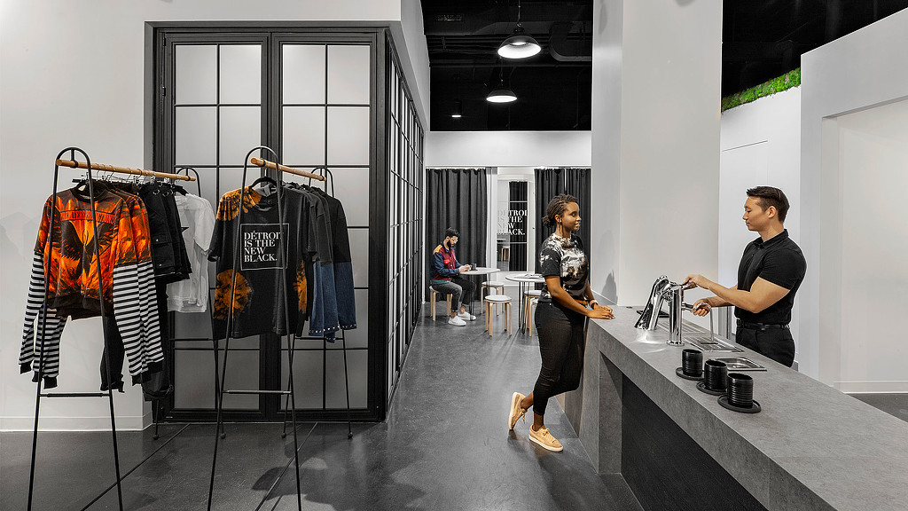 A man and a woman in a clothing store.