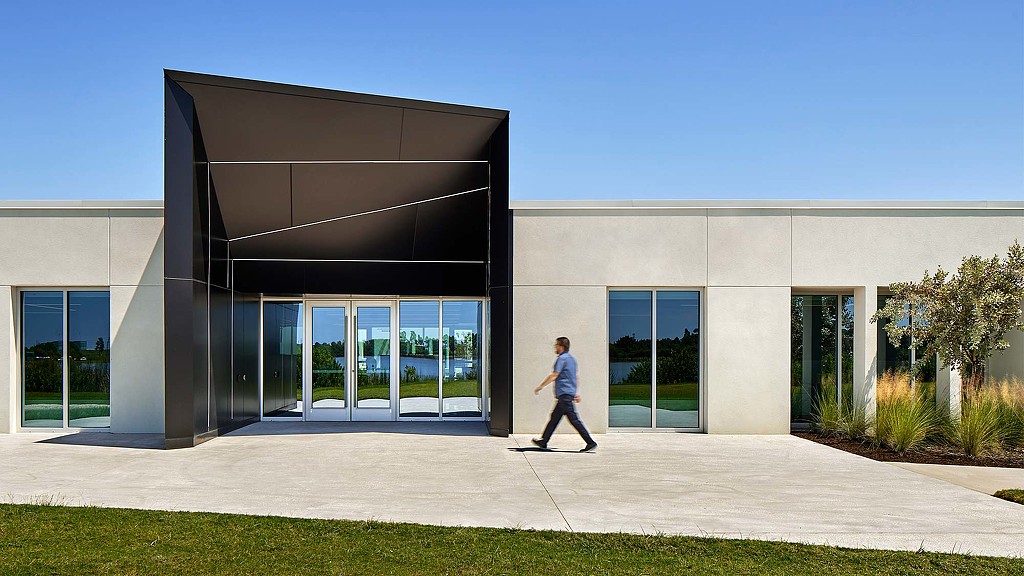 A person walking outside of a building.