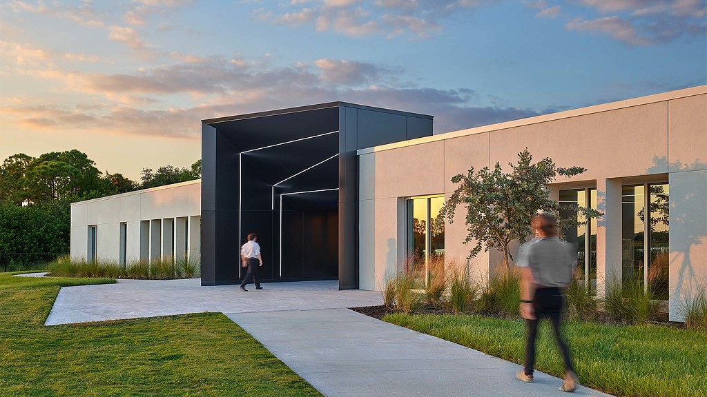 A man and a woman walking outside of a building.