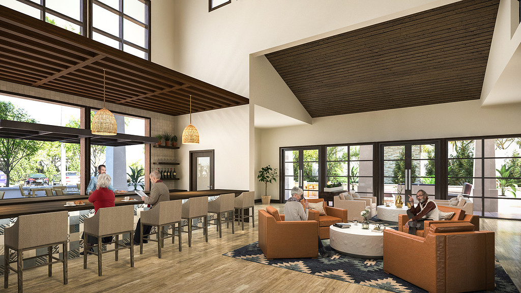 A group of people sitting at a table in a large room.