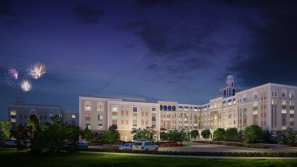 A building with a lot of windows and cars parked in front.