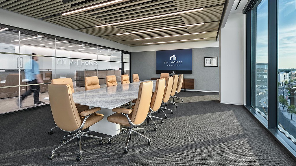 A conference room with a table and chairs.