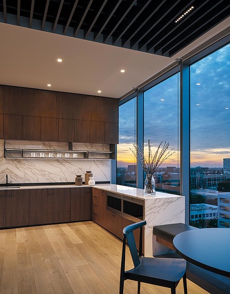 A room with a large window and chairs.