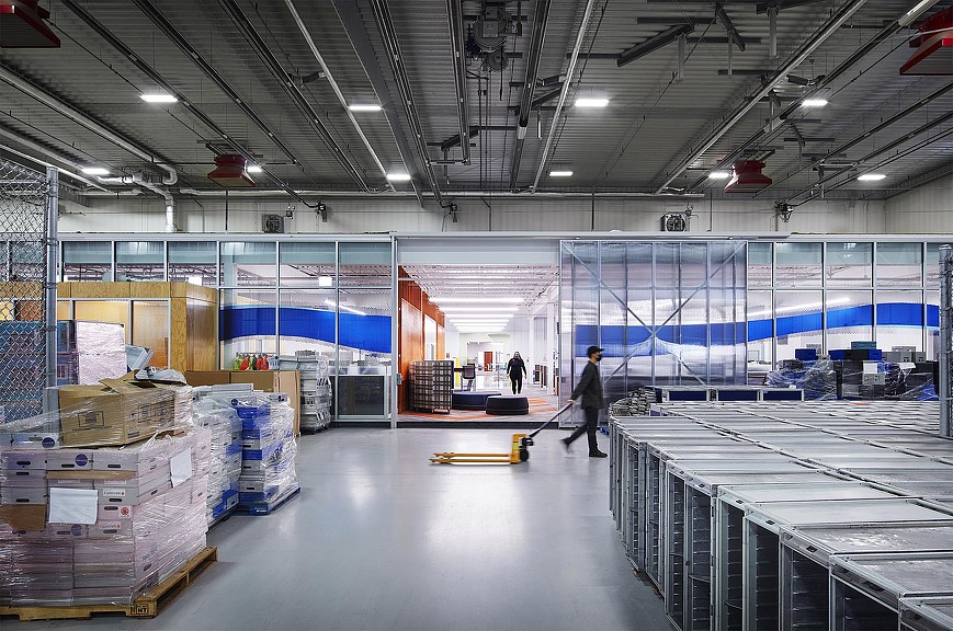 A warehouse with a few people.