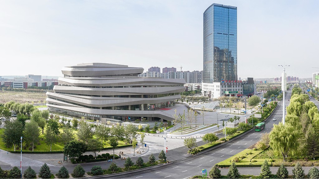 A large building with a parking lot.