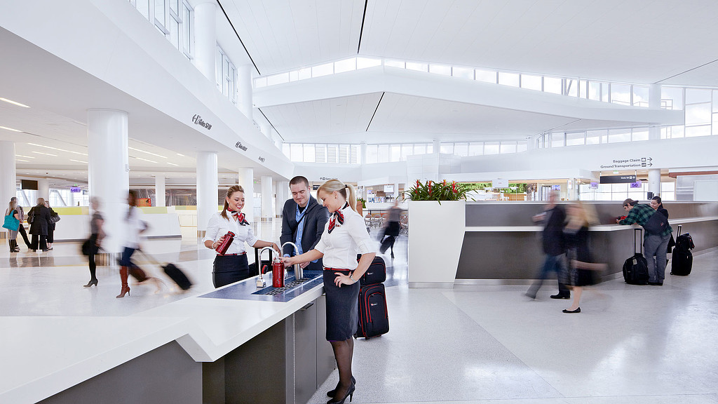 A group of people standing in an airport.