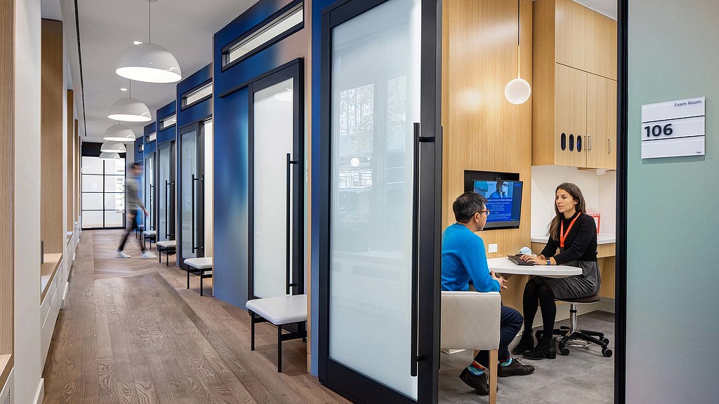 A man and a woman sitting at a table in a room.