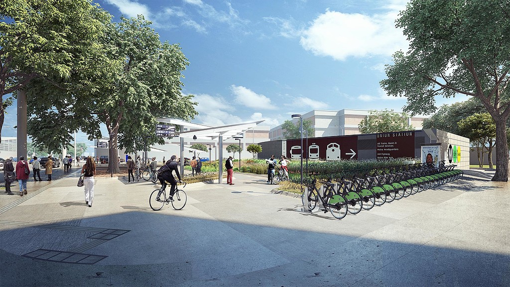 A group of people riding bikes on a street.