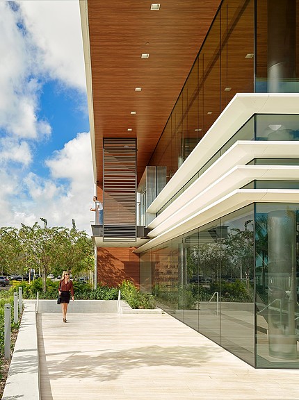 A person walking outside of a building.