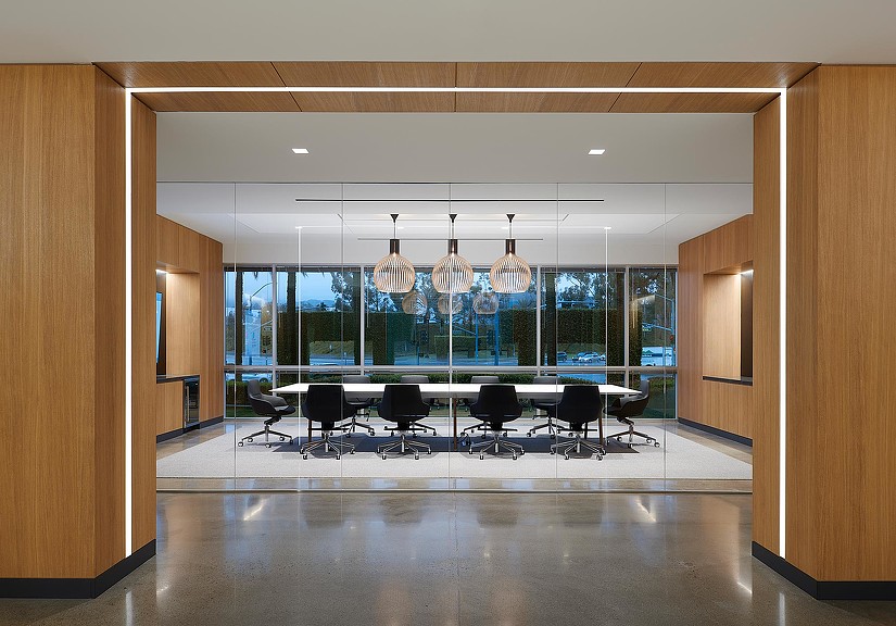 A room with a large window and chairs.