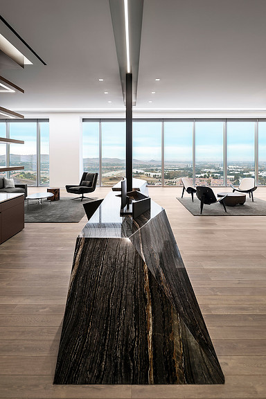 A room with a table and chairs and large windows with large windows.