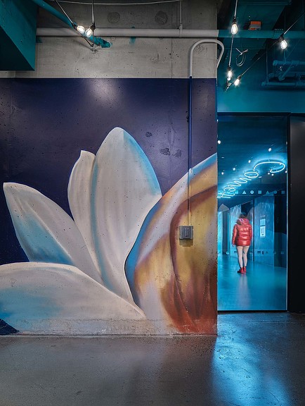 A person standing next to a large sculpture.