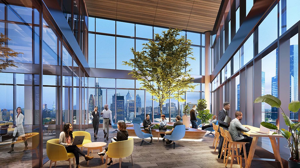 People sitting at tables in a large building with windows.