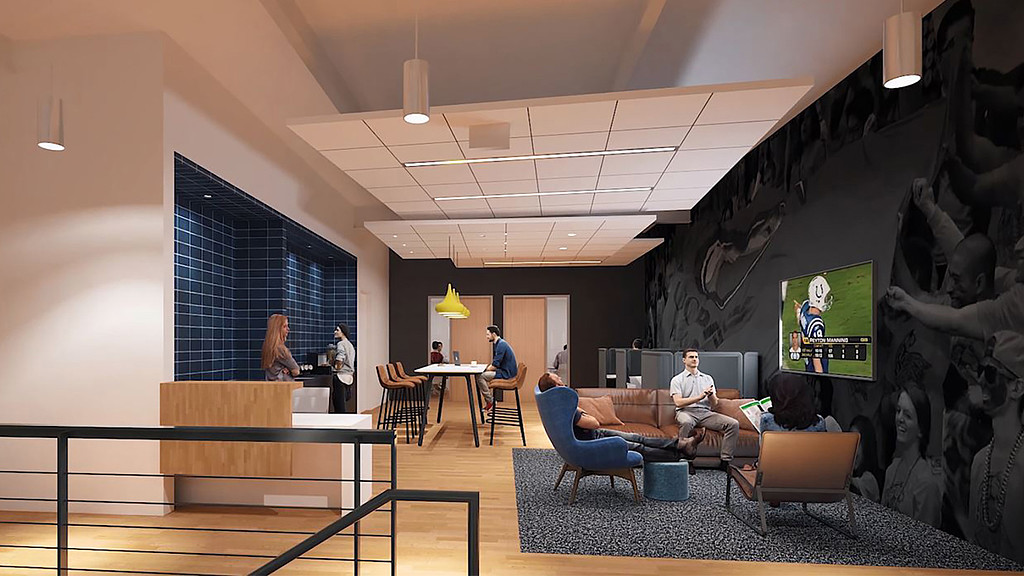 A room with a couch and a table with people sitting at it.