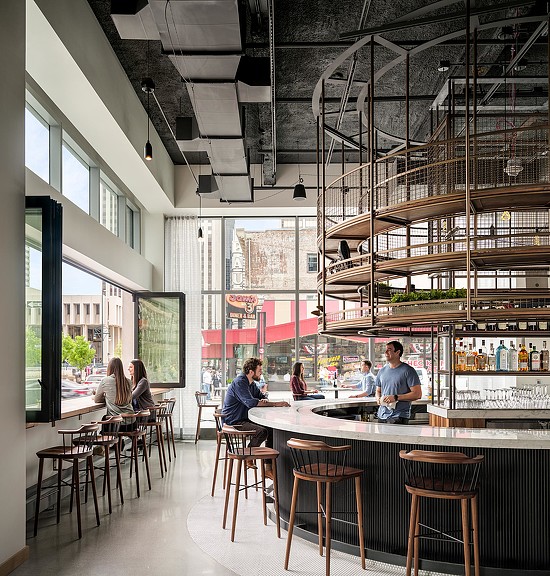 A group of people sitting at a table in a restaurant.