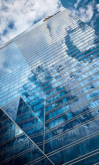 Low Angle Shot of the Marriott Marquis at McCormick Place with Reflection of Trees and Clouds