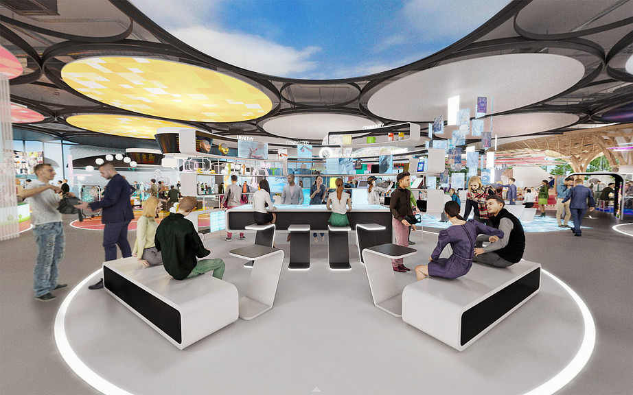 A group of people in a large room with white couches.