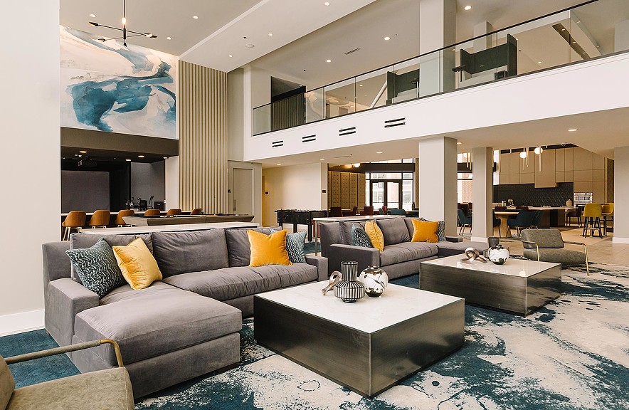 A living room with a large glass wall.