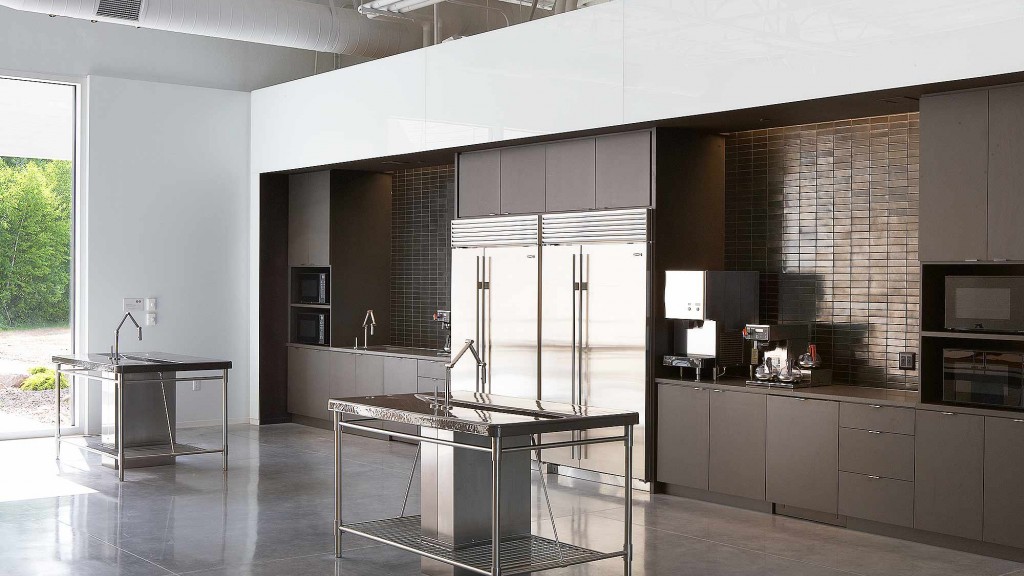 A kitchen with a refrigerator and a table.