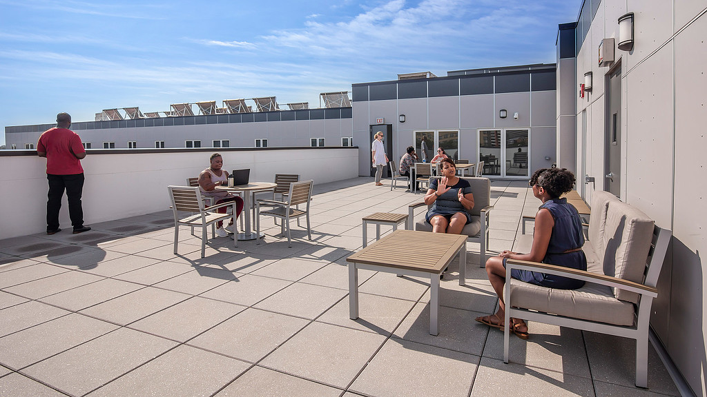 People sitting on benches outside.