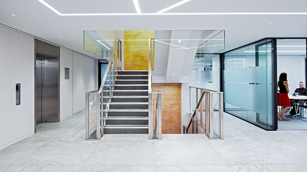 A person standing next to a staircase.