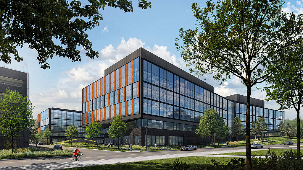 A building with a person riding a bicycle.