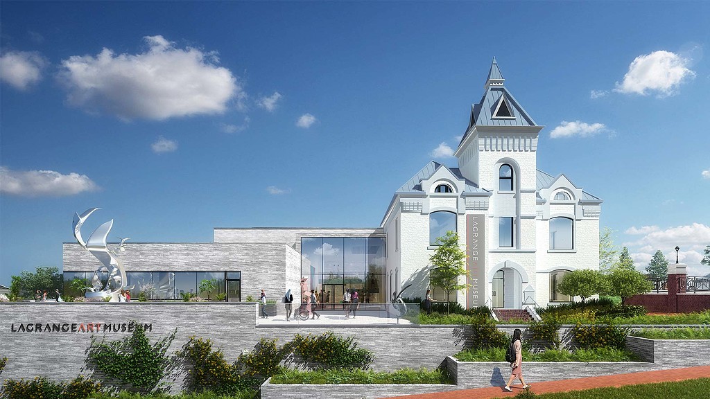 A white building with a statue in front of it.