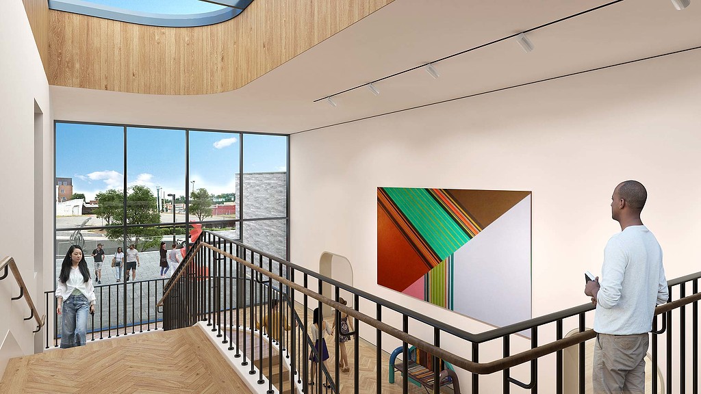 A man painting on a wall.