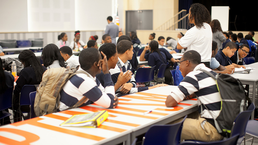 A group of people sitting at tables.