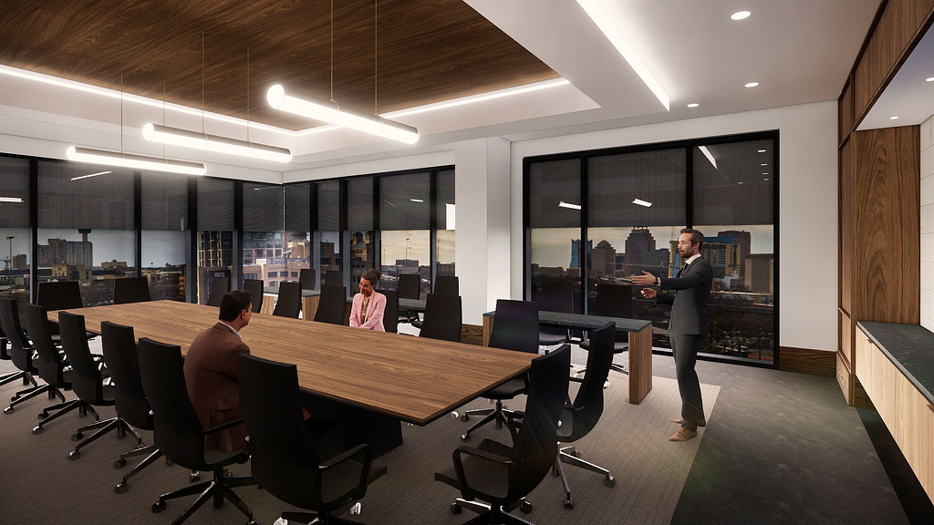 A person standing in front of a table with people sitting at it.