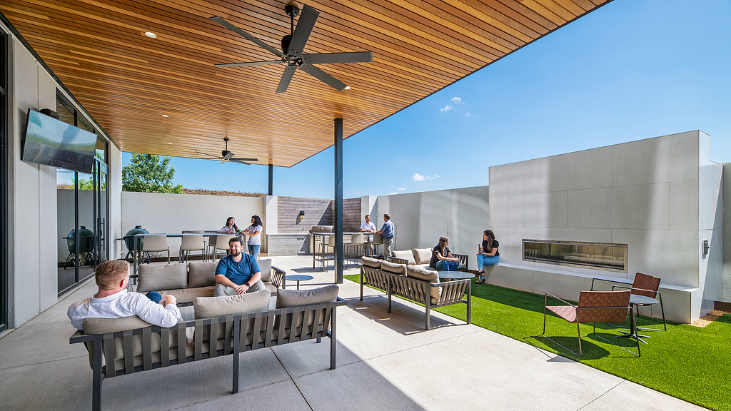 People sitting on benches in a room.