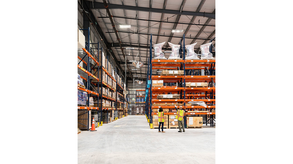 A warehouse with several people.