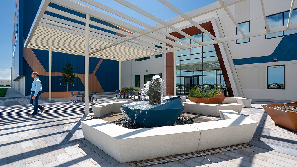 A person walking in a courtyard.