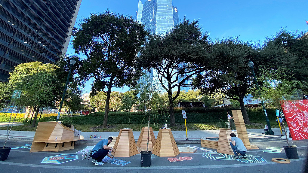 A group of people playing in a park.