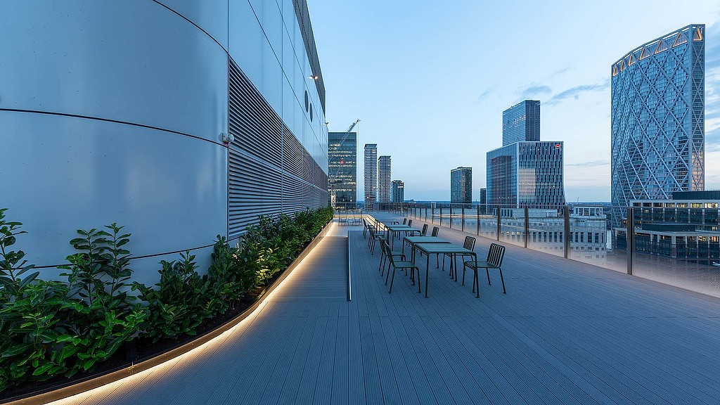 A walkway with benches and tables.
