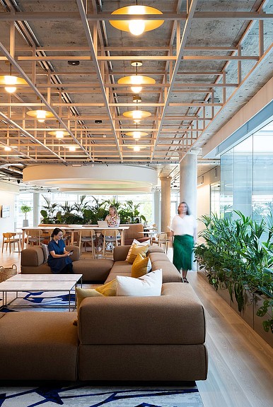 A man and a woman in a large room with a large glass ceiling.