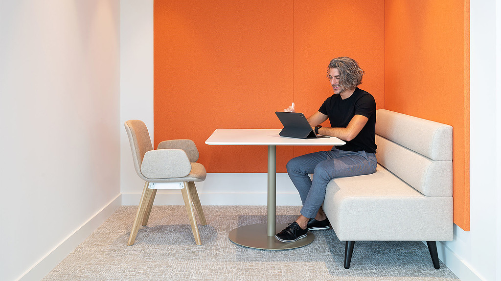 A man sitting at a table with a laptop.