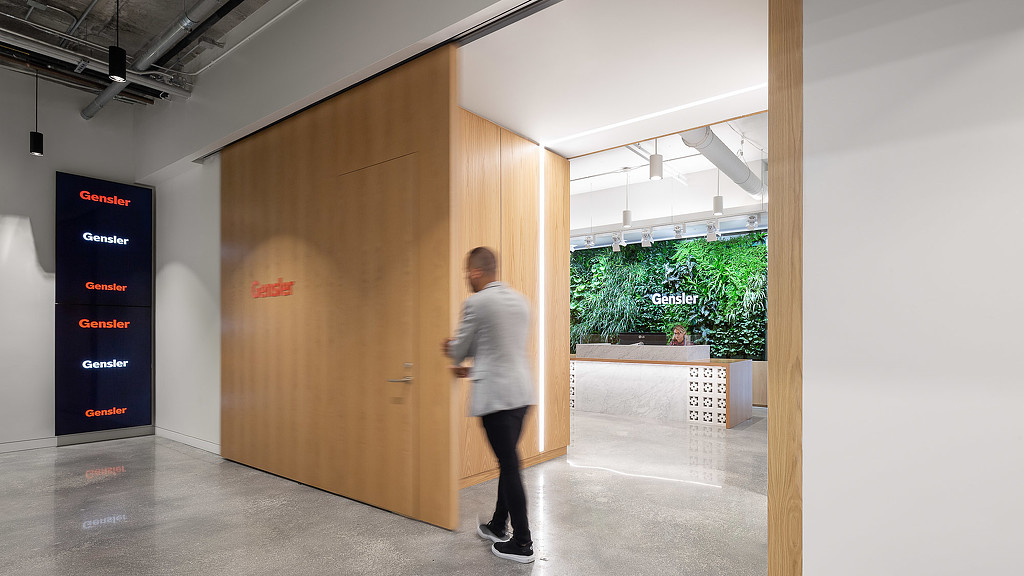 A man standing in a hallway.