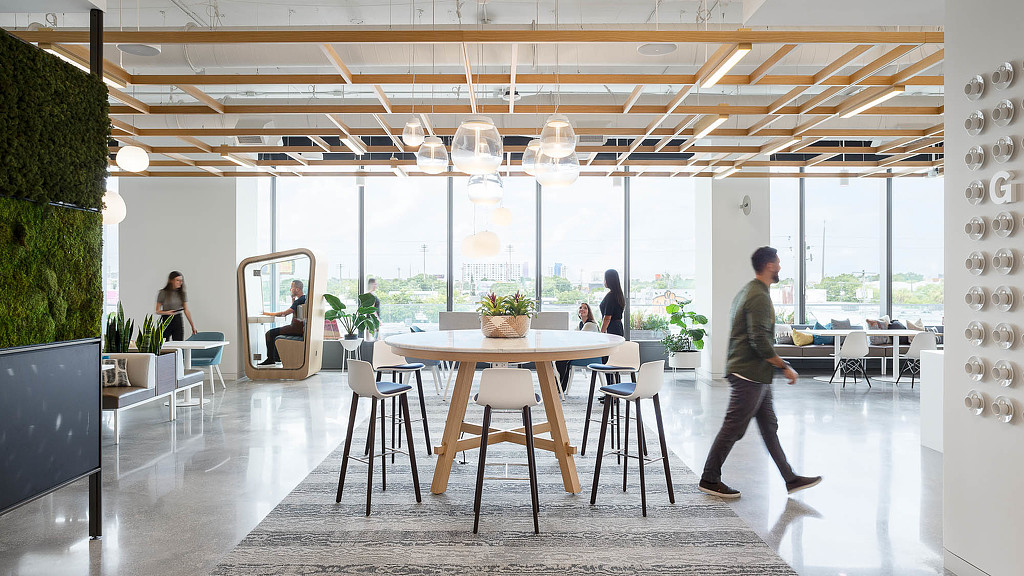 A man walking in a large room.