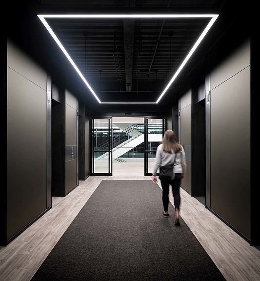 A person walking down a hallway.